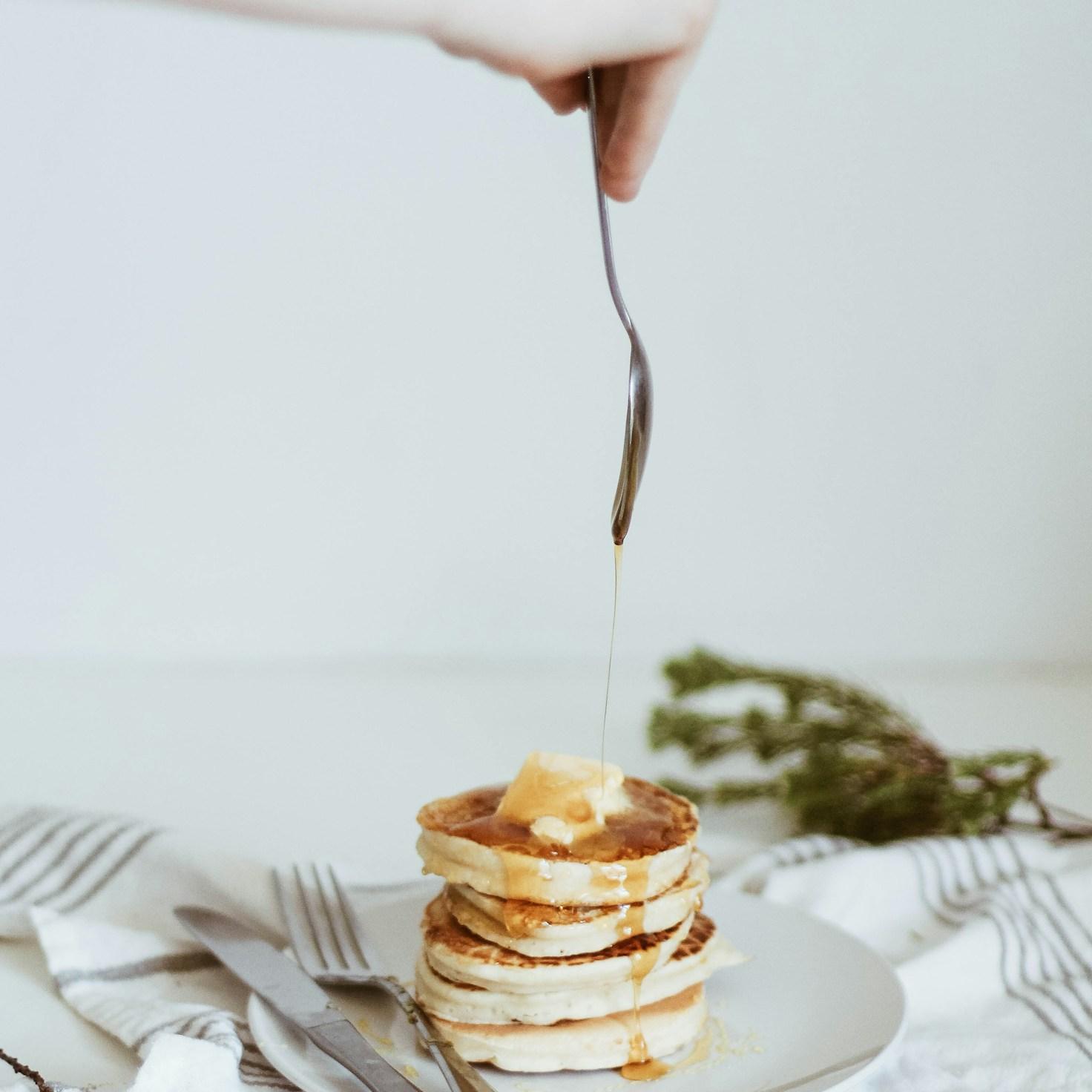 Diverse group of community members sharing a meal together, showcasing the social bonds formed through collaborative cooking